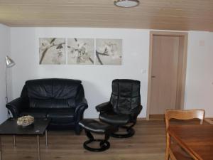 a living room with a chair and a couch at Apartment Leinacherhof by Interhome in Seeberg