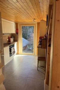 an empty kitchen with a large window in a house at Apartment Peak App- Morgins by Interhome in Morgins +25 photos