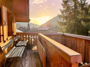 two benches sitting on a balcony with a view at Apartment Peak App- Morgins by Interhome in Morgins