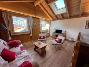 a living room with a couch and a table at Apartment Peak App- Morgins by Interhome in Morgins