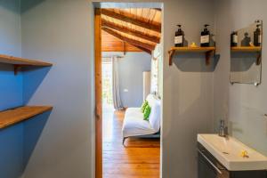 a bathroom with a sink and a mirror at Moorea Maatea Tahatai Lodge in Moorea +90 photos