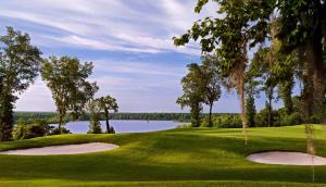 a golf course with a view of a lake at Preston Suites by IHG in Montgomery