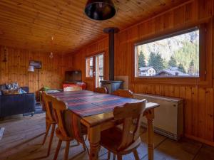 a dining room with a table and a window at Apartment Base Camp Evolène by Interhome in Evolène