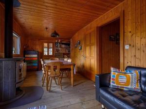 a living room with a table and a couch in a cabin at Apartment Base Camp Evolène by Interhome in Evolène