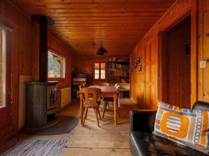 a living room with a table and a stove at Apartment Base Camp Evolène by Interhome in Evolène
