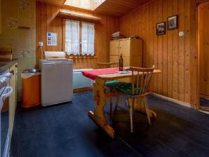 a kitchen with a table and a refrigerator at Apartment Base Camp Evolène by Interhome in Evolène