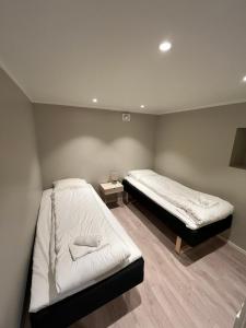 a bedroom with two beds in a room at Skolegata 6B, 9404 Harstad in Harstad