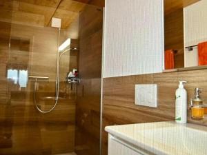a shower with a glass door in a bathroom at Apartment Panorama-Beatenberg by Interhome in Beatenberg
