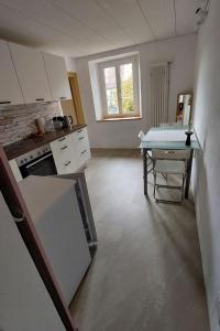 a kitchen with a table and a counter top at Apartment Giselas Ruheplatz by Interhome in Liesberg