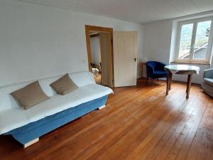 a bedroom with a bed and a table in a room at Apartment Giselas Ruheplatz by Interhome in Liesberg