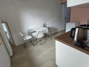 a kitchen with a table and chairs in a kitchen at Apartment Giselas Ruheplatz by Interhome in Liesberg
