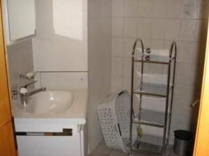 a small bathroom with a sink and a mirror at Apartment Muessache by Interhome in Dürrenroth