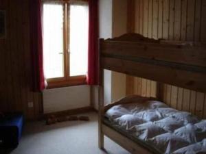 a bedroom with a bunk bed and a window at Apartment Muessache by Interhome in Dürrenroth