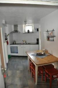 a kitchen with a wooden table and a table and chairs at Apartment Stöckli by Interhome in Attiswil
