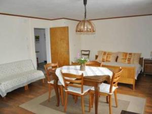 a dining room with a table and chairs and a bedroom at Apartment Stöckli by Interhome in Attiswil