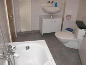 a bathroom with a tub and a sink and a toilet at Apartment Stöckli by Interhome in Attiswil