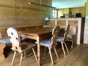 a wooden table and chairs in a room at Apartment Chalet Ried by Interhome in Diemtigen
