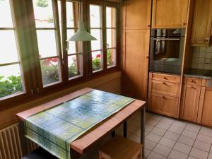 a kitchen with a table and some windows at Apartment Chalet Ried by Interhome in Diemtigen +37 photos