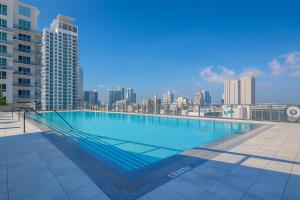 a large swimming pool on the roof of a building at Bay Views Studio in Miami