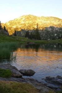 a body of water with a mountain in the background at Apartment Appartement Eggmatte by Interhome in Grimmialp