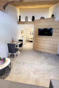 a living room with a wall with a flat screen tv at Apartment Chalet Lilo Studio by Interhome in Beatenberg +23 photos