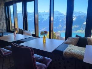a table in a room with a view of mountains at Apartment Hotel Apartment by Interhome in Beatenberg +32 photos