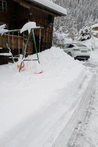 a pile of snow in front of a house at Apartment Ferienwohnung by Interhome in Blankenburg