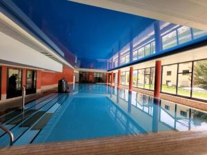 a large swimming pool in a building with a blue ceiling at Apartment Hotel Apartment by Interhome in Beatenberg