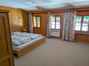 a bedroom with a bed and two windows at Apartment Ferienwohnung by Interhome in Blankenburg +8 photos