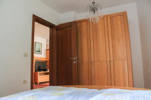 a bedroom with a closet and a chandelier at Apartment Felicia in Portorož