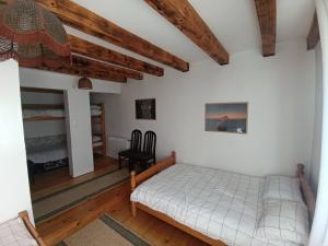 a bedroom with a bed and a chair at Vikendica SANA Vlašić in Šišava +4 photos