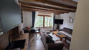 a living room with a couch and a table at Vikendica SANA Vlašić in Šišava