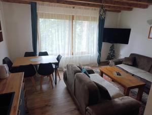 a living room with a couch and a table at Vikendica SANA Vlašić in Šišava