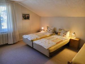 a small bedroom with a bed and a window at Apartment Chalet Lilo Big view by Interhome in Beatenberg +22 photos