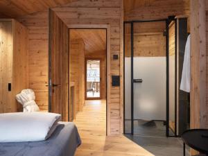 a bedroom with a bed and a glass door at Apartment My Chalet by Interhome in Meiringen