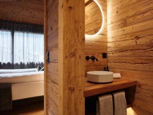 a bathroom with a sink in a wooden wall at Apartment My Chalet by Interhome in Meiringen