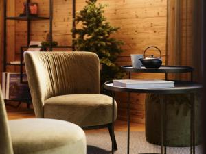 a chair and a table and a christmas tree at Apartment My Chalet by Interhome in Meiringen
