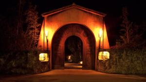 an entrance to a house with an archway at night at Hôtel Le Belvédère in Porto-Vecchio