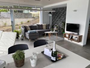 a living room with a couch and a table with wine bottles at Apartment Gemütliche Apartment by Interhome in Krattigen +22 photos