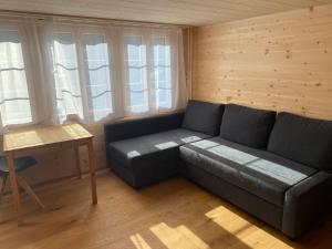 a living room with a couch and a table at Apartment Alpenruh by Interhome in Gadmen