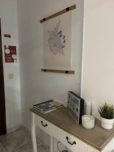 a table with a book and a clock on it at Apartamento próximo da praia e do centro da cidade in Póvoa de Varzim
