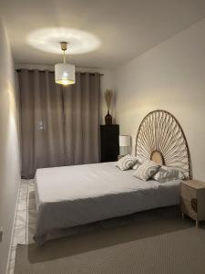 a bedroom with a large white bed and a chandelier at Apartamento próximo da praia e do centro da cidade in Póvoa de Varzim +8 photos