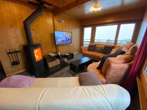 a living room with a couch and a stove at Apartment Hockenhorn by Interhome in Wiler