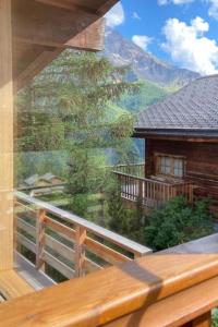 a view from the balcony of a log cabin with a mountain view at Apartment Hockenhorn by Interhome in Wiler