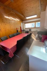 a conference room with a long red table and chairs at Apartment Hockenhorn by Interhome in Wiler +19 photos