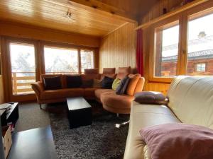 a living room with couches and a couch and windows at Apartment Hockenhorn by Interhome in Wiler