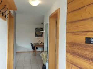 a hallway with a sliding barn door and a table at Apartment Aspa EG by Interhome in Bellwald