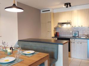 a kitchen with a table with plates and glasses on it at Apartment Aspa EG by Interhome in Bellwald