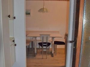 a dining room table and chairs with a table and a dining room at Apartment Steinideen by Interhome in Meiringen