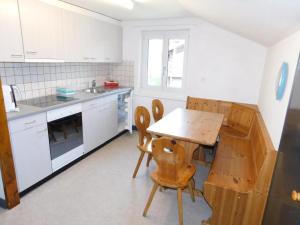 a kitchen with a wooden table and chairs at Apartment Alter Konsum by Interhome in Bellwald